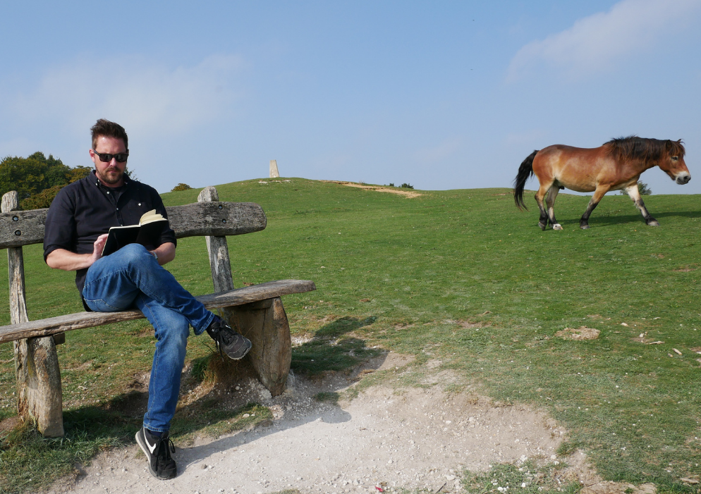 Rob Lambert sat on a bench in the countryside