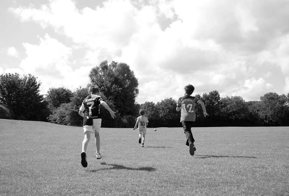 Kids running through a park