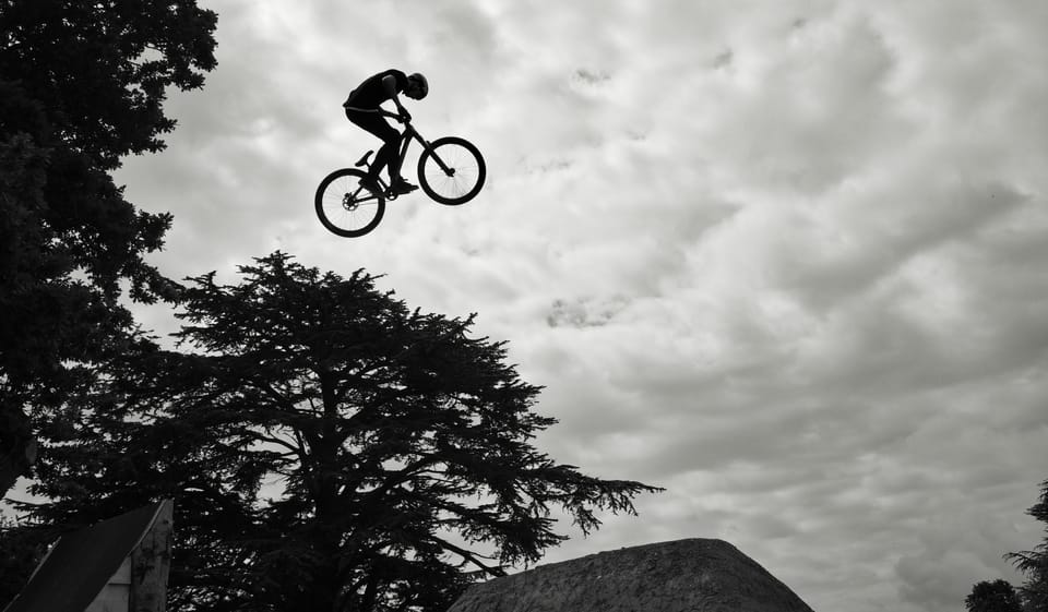 A photo of someone on a bike jumping through the air