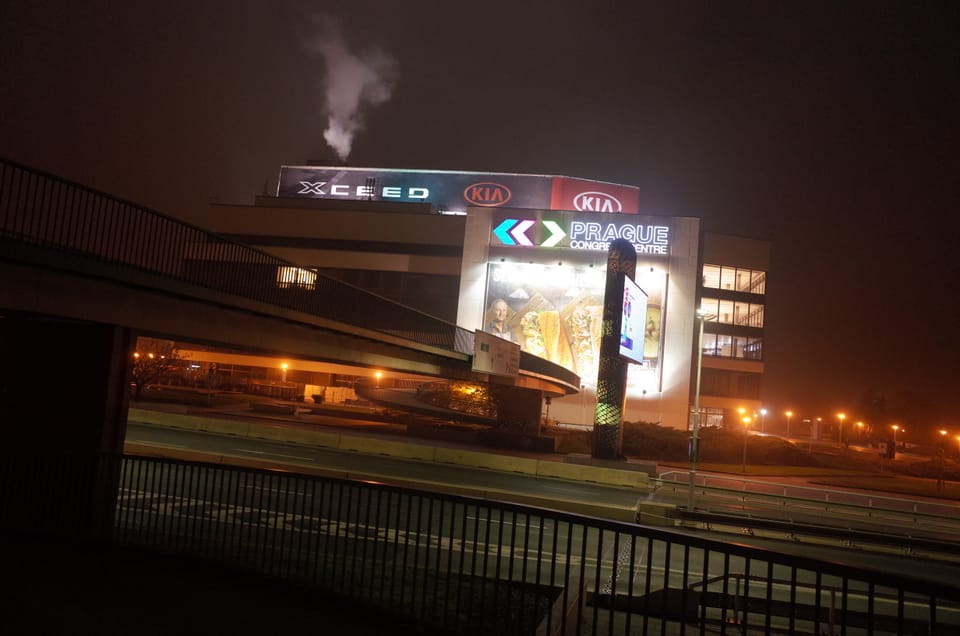 A photo of a building with a Kia advert on the side - somewhere in Prague