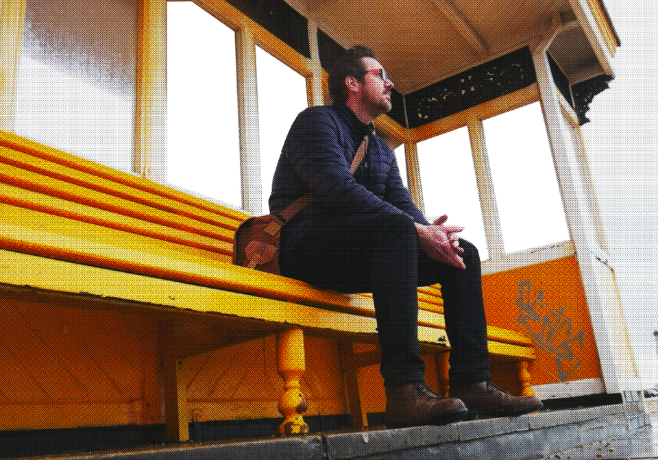 A photo of Rob Lambert sat on a bench 